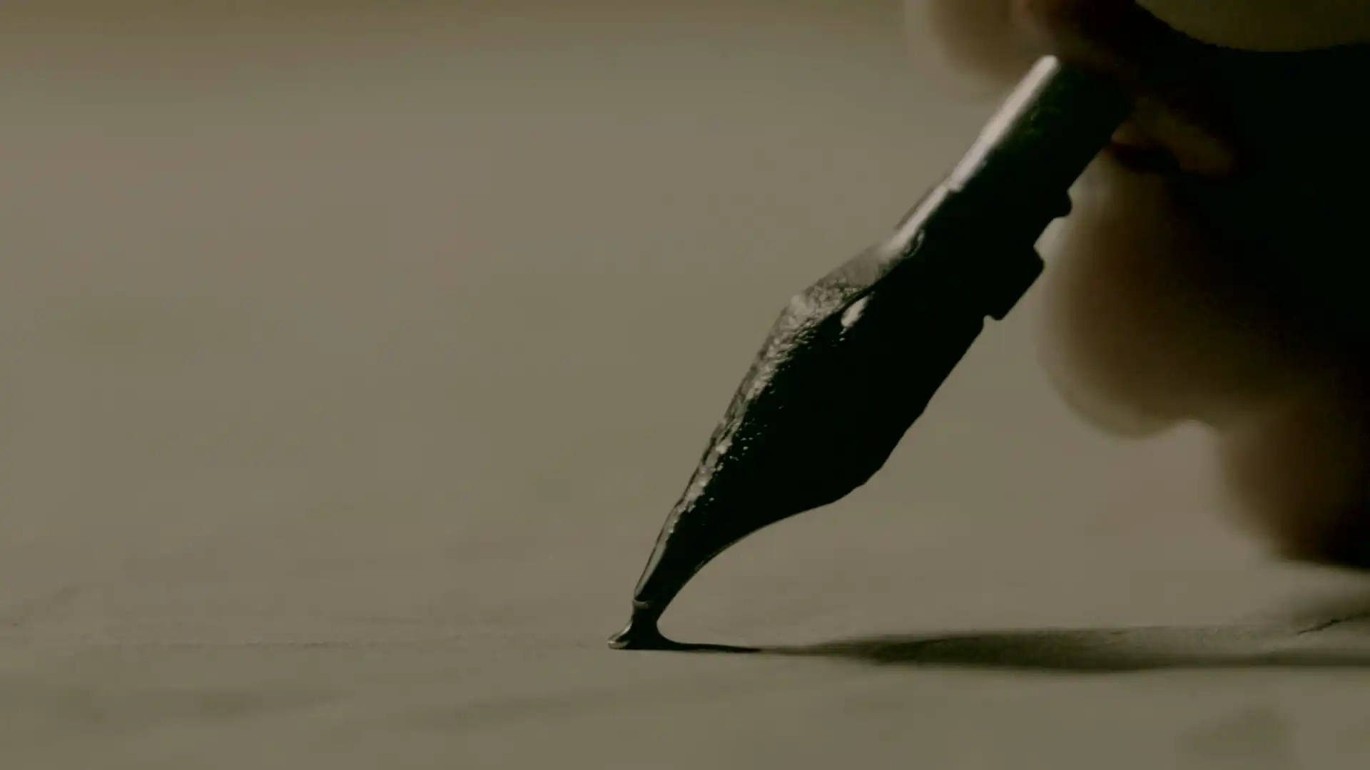 A fountain pen writing in ink, then oak barrels in a dim cellar