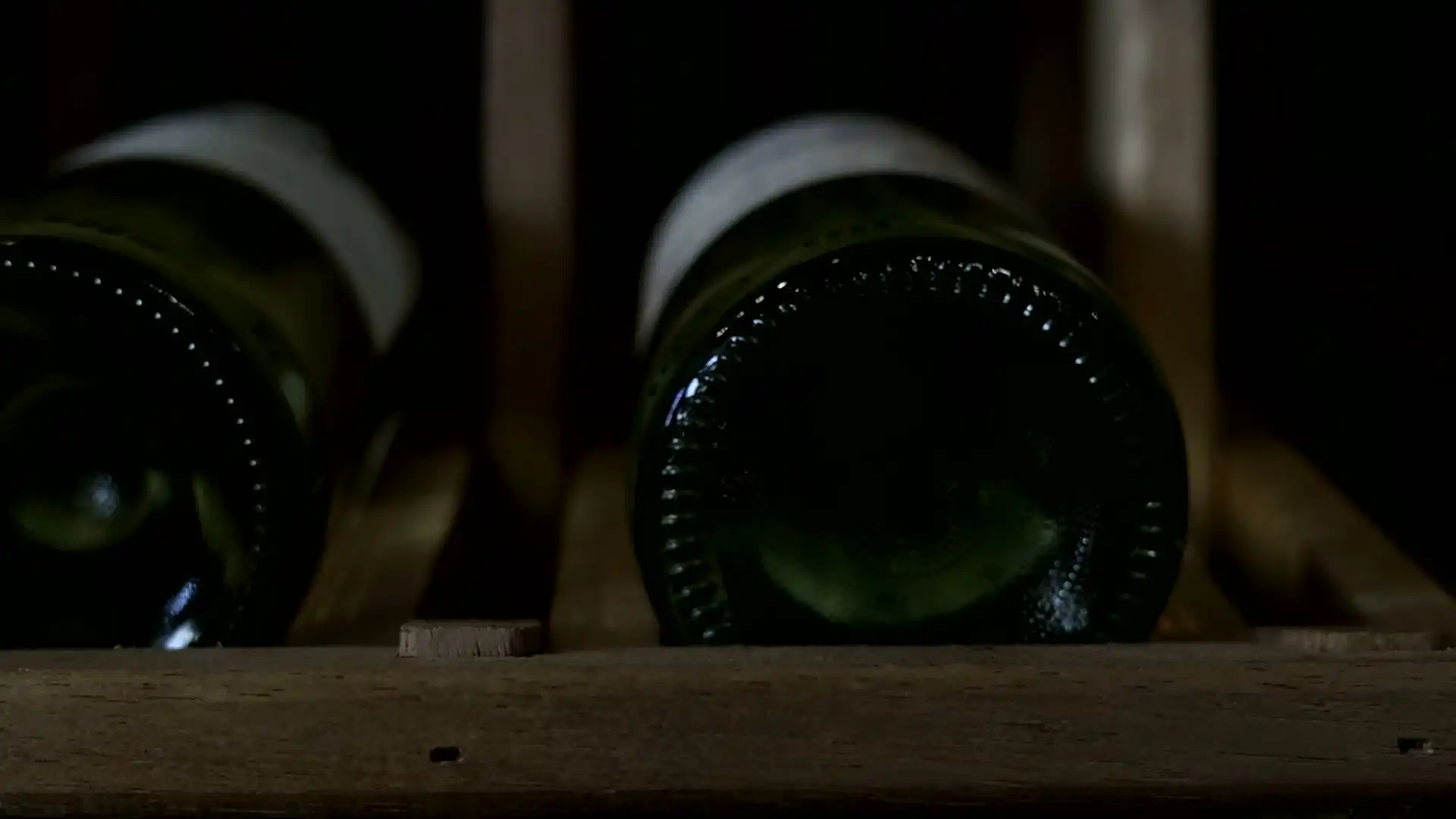 Bottles lying on their sides in a wine rack