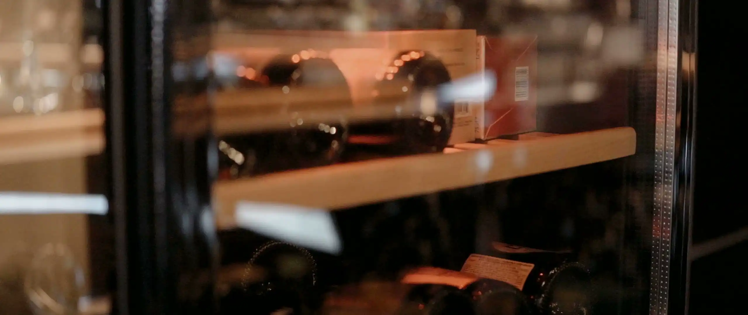 Bottles on cellar shelves in warm light